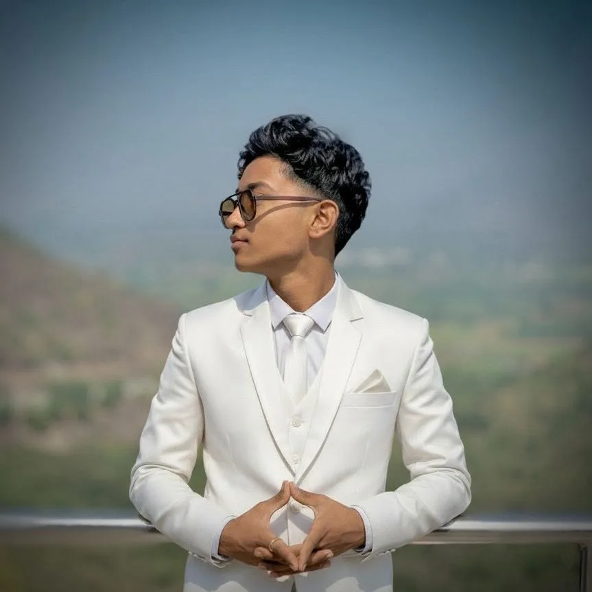 Portrait of Mohit Chilakala in a white suit